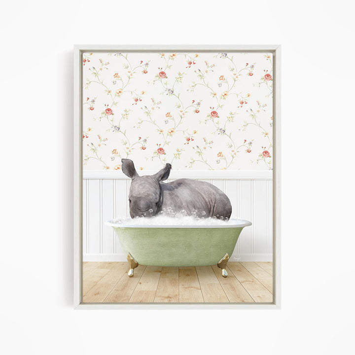 A rhinoceros is sitting in a green bathtub filled with water, surrounded by a floral wallpaper.