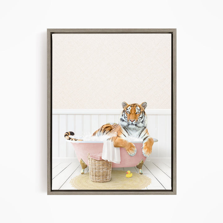 A tiger is sitting in a pink bathtub, surrounded by a basket of toys and a yellow rubber duck, creating a whimsical and playful scene.