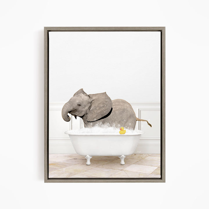 A gray elephant is standing in a white bathtub filled with water, with a yellow rubber duck floating on the water.