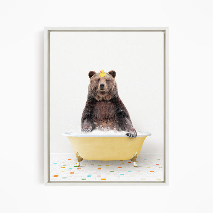 A brown bear sitting in a yellow bathtub filled with water, with a yellow rubber duck floating on the water.