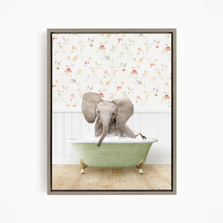 A gray elephant sitting in a green bathtub filled with water, surrounded by a floral wallpaper.