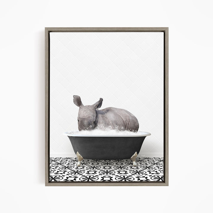 A rhinoceros is sitting in a bathtub filled with water, creating a whimsical and playful scene.