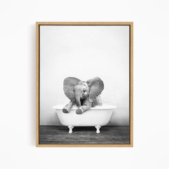 A baby elephant sitting in a bathtub filled with water, appearing to enjoy the bath.