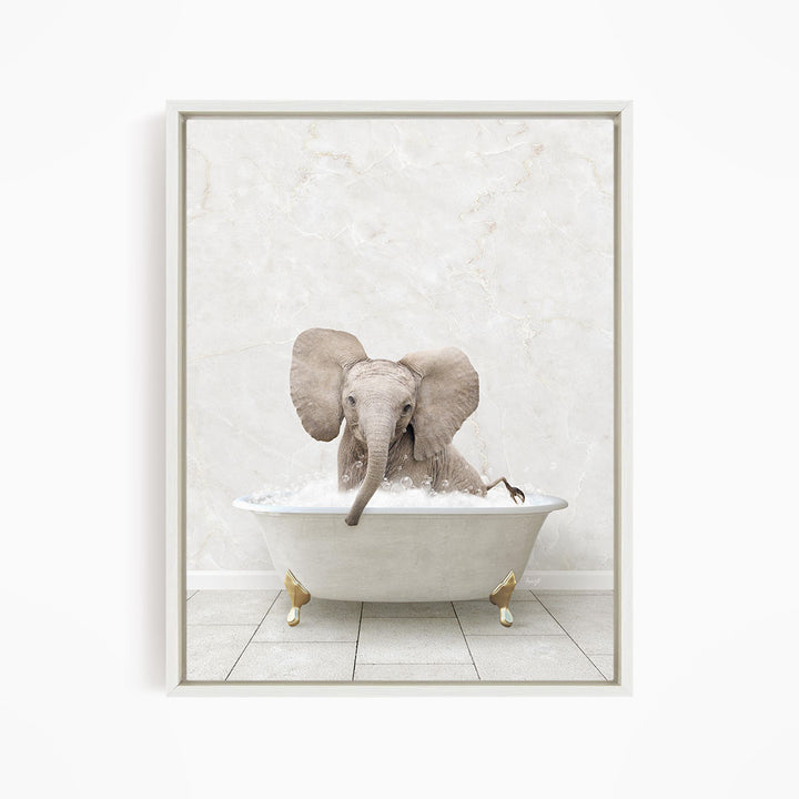 A baby elephant sitting in a white bathtub filled with water, appearing to enjoy the bath.