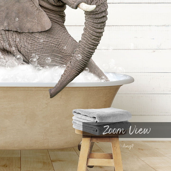 A large elephant is taking a bath in a bathtub, surrounded by bubbles, with a towel and stool nearby.