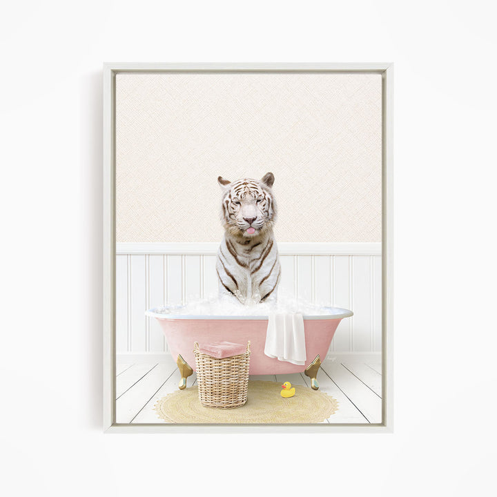 A white tiger sits in a pink bathtub filled with bubbles, surrounded by a yellow rubber duck and a wicker basket.