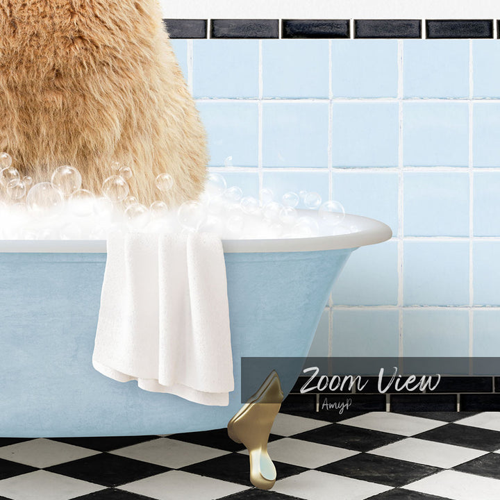 A fluffy brown cat sitting in a blue bathtub filled with bubbles, with a towel draped over the side and a checkered black and white floor in the foreground.