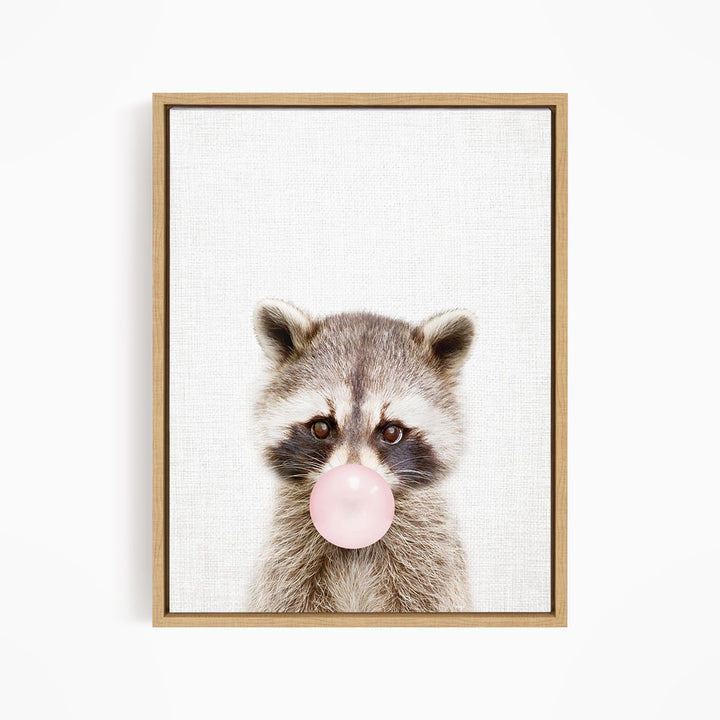 A raccoon blowing a bubble with a pink bubble gum bubble.