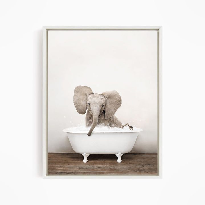 A baby elephant sitting in a white bathtub filled with water, with its trunk submerged in the water.