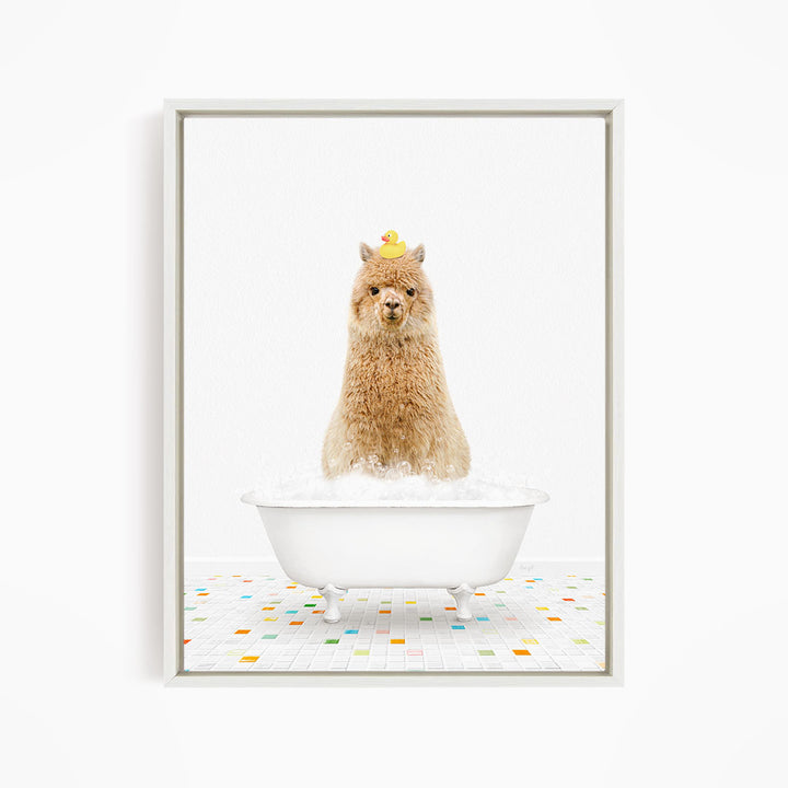 A fluffy brown llama sits in a white bathtub filled with bubbles, with a yellow rubber duck perched on its head.