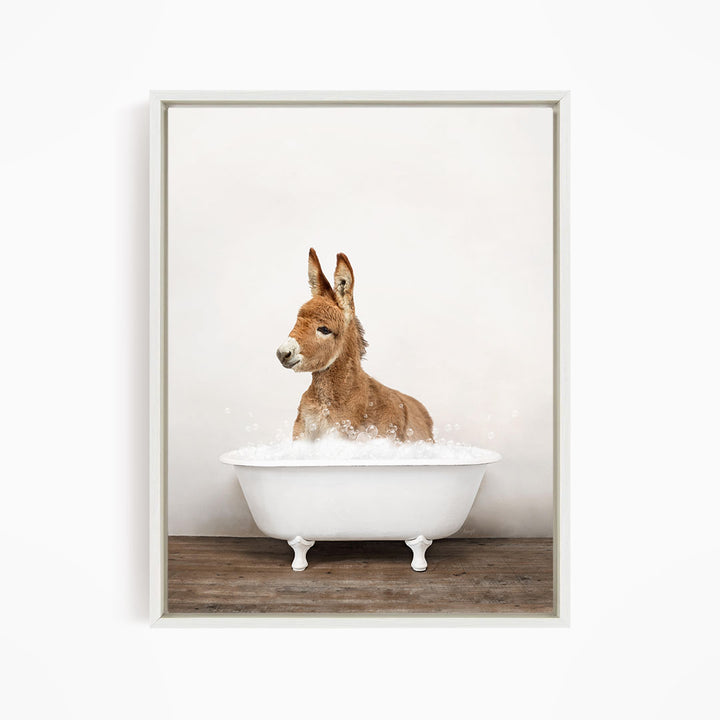 A donkey is sitting in a white bathtub filled with water, creating a playful and whimsical scene.