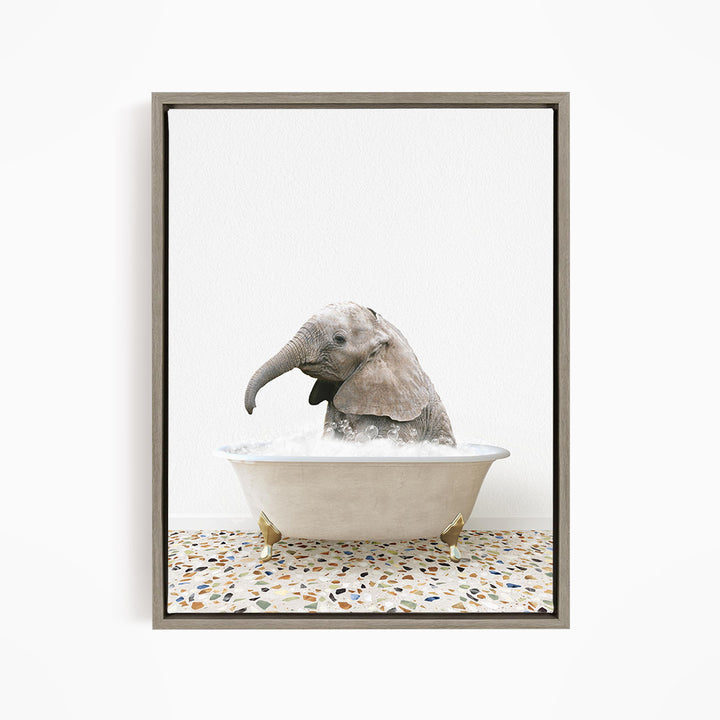 A baby elephant sitting in a bathtub filled with water, with its trunk submerged in the water.