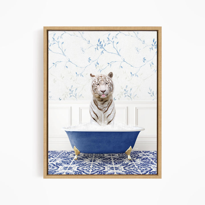 A white tiger is sitting in a blue bathtub filled with water, surrounded by a blue and white patterned rug on the floor.