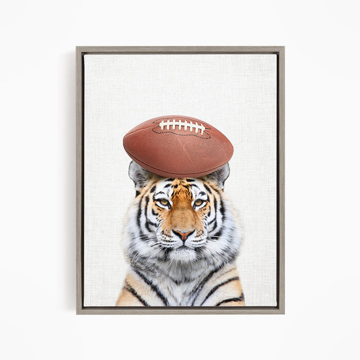 A tiger with a football resting on its head.