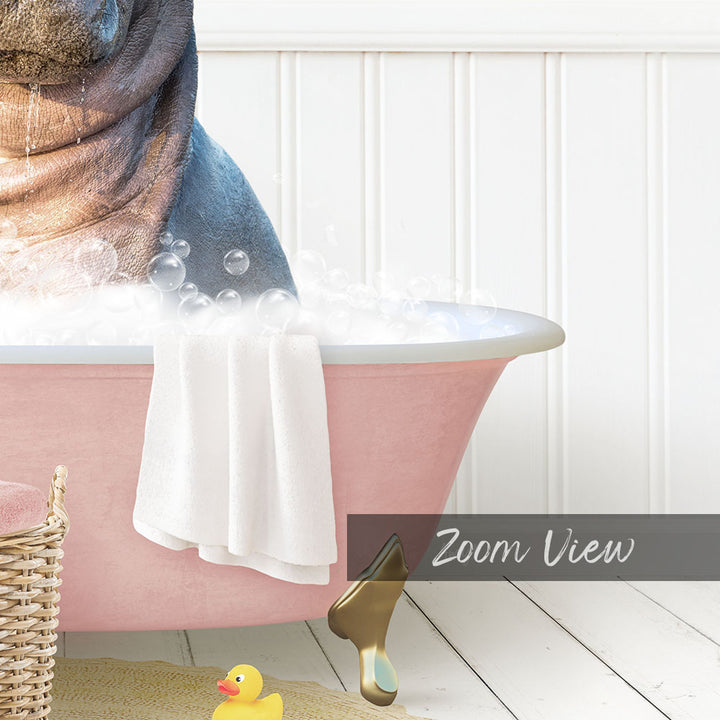 A pink bathtub filled with bubbles, with a towel and a rubber duck nearby.