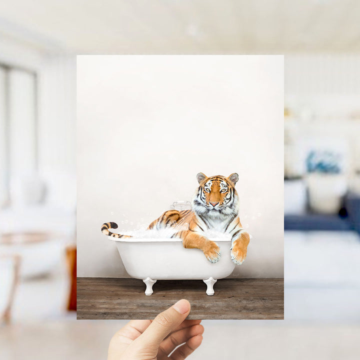 A tiger is sitting in a white bathtub, appearing relaxed and comfortable.