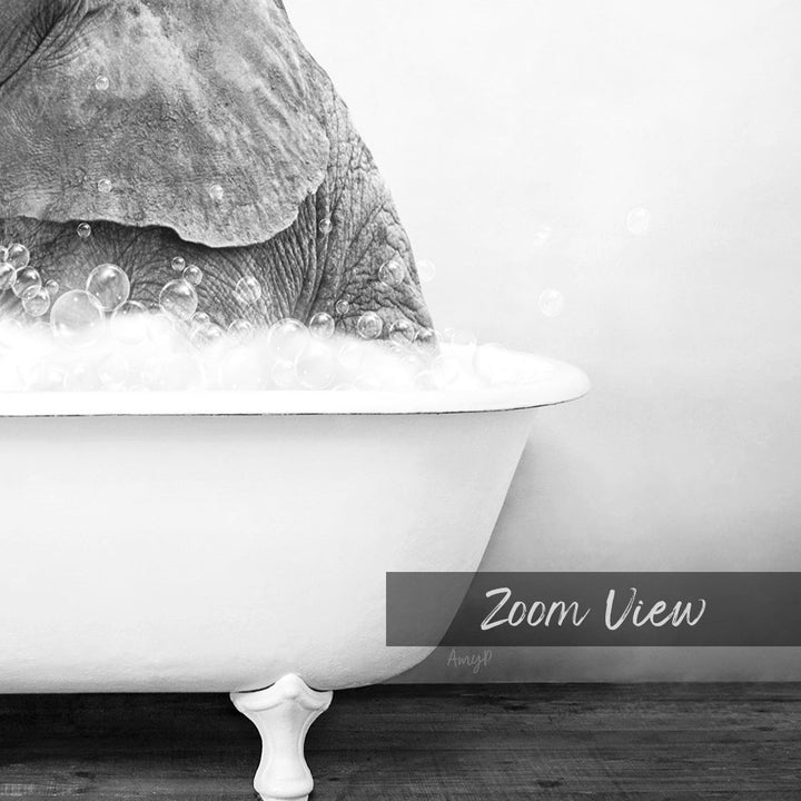 A close-up black and white image of an elephant submerged in a bathtub filled with bubbles.