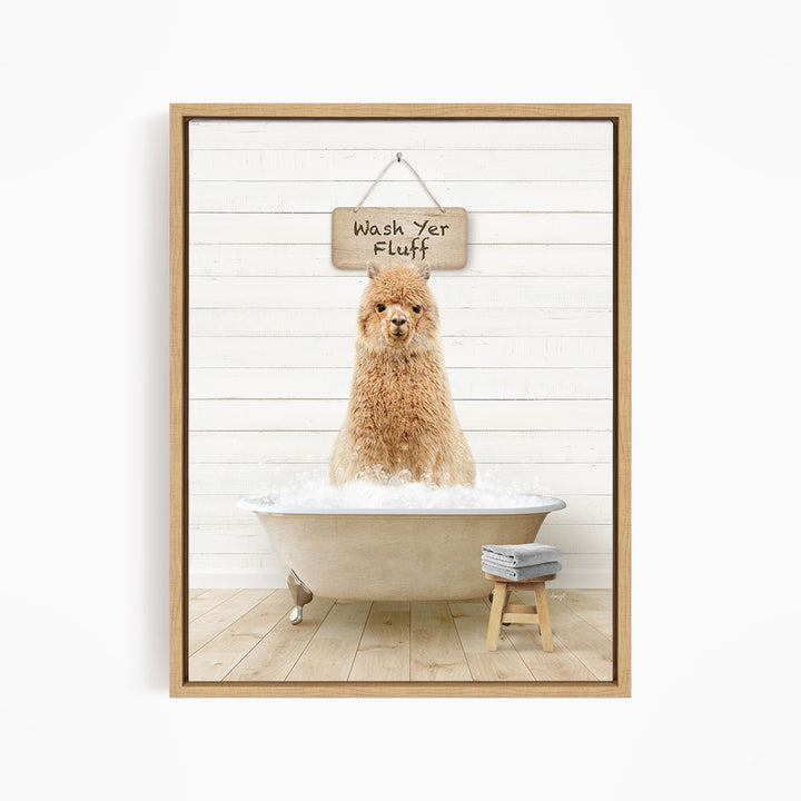 A fluffy brown dog sitting in a bathtub filled with bubbles, with a sign above that says "Wash Yer Fluff".