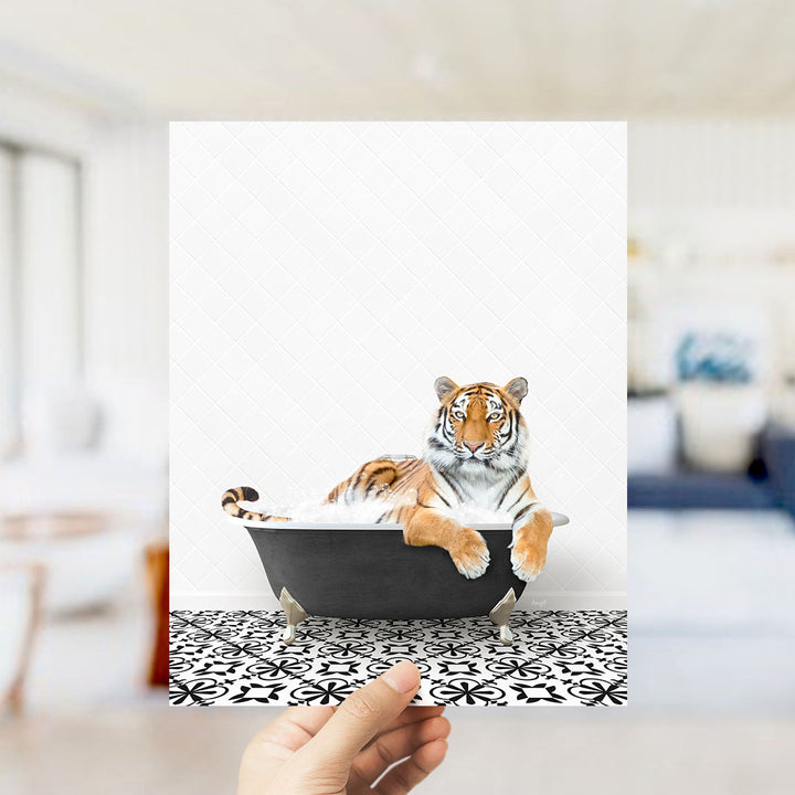 A tiger is sitting in a bathtub, surrounded by a black and white patterned floor.