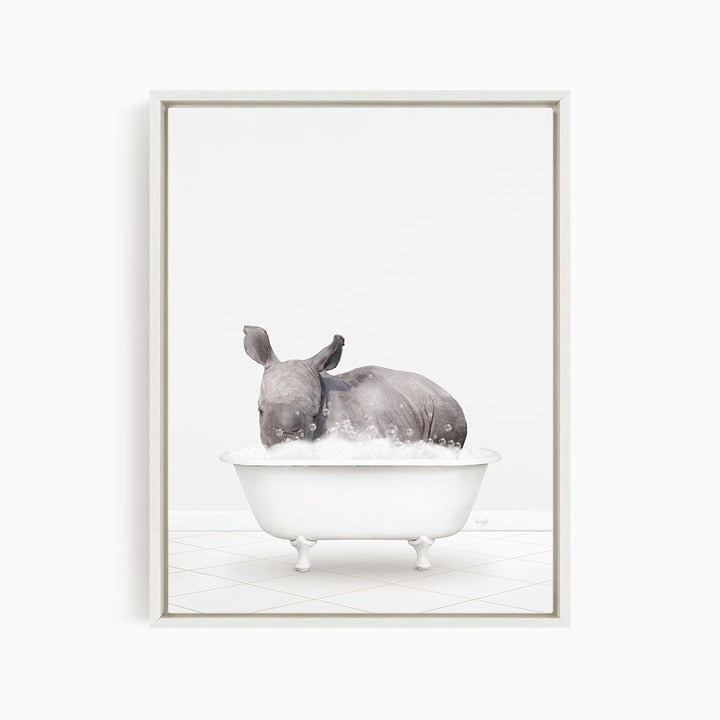 A rhinoceros is sitting in a white bathtub filled with water, creating a whimsical and playful scene.