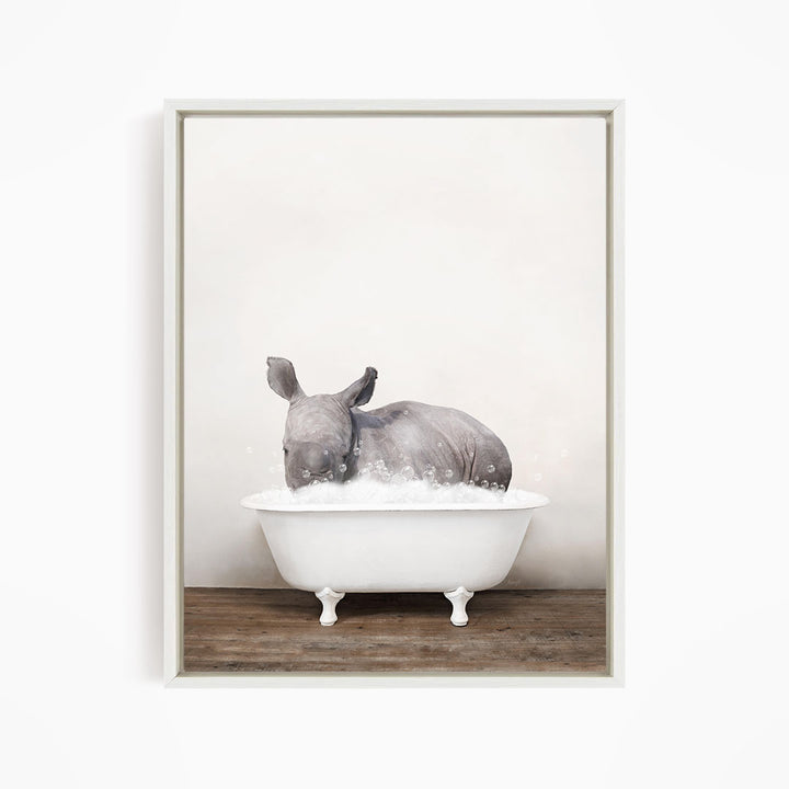 A rhinoceros is sitting in a white bathtub filled with water, creating a whimsical and playful scene.