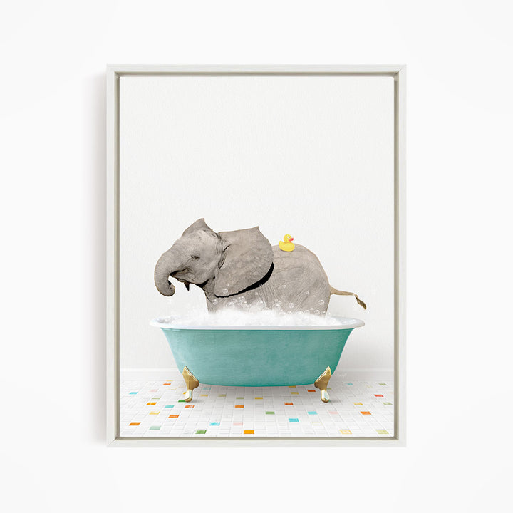 A gray elephant is sitting in a blue bathtub, with a yellow rubber duck on its back.