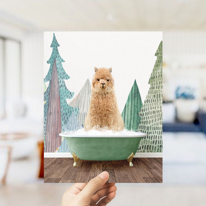 A hand holds up a framed image depicting a fluffy brown dog sitting in a green bathtub, surrounded by a winter landscape with trees and snow.