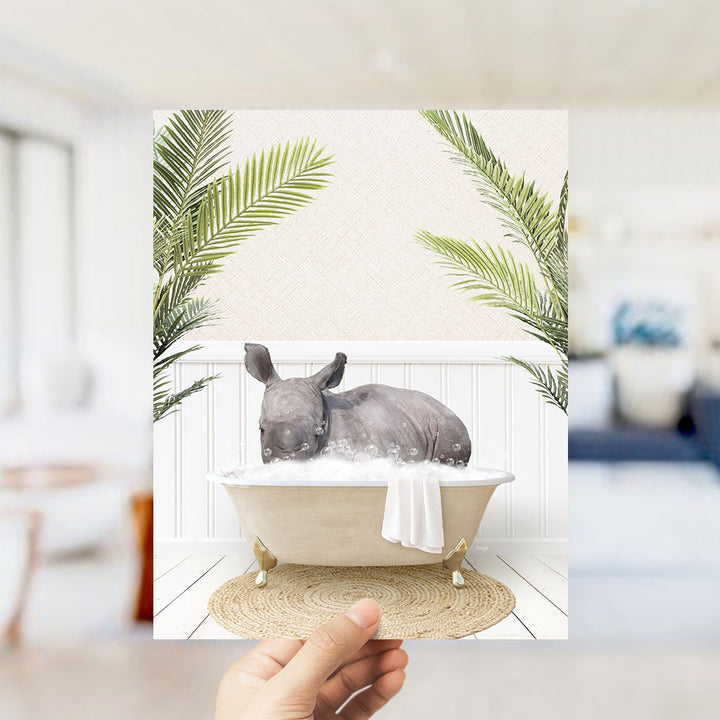 A rhinoceros is sitting in a bathtub filled with bubbles, surrounded by green palm leaves, creating a whimsical and playful scene.