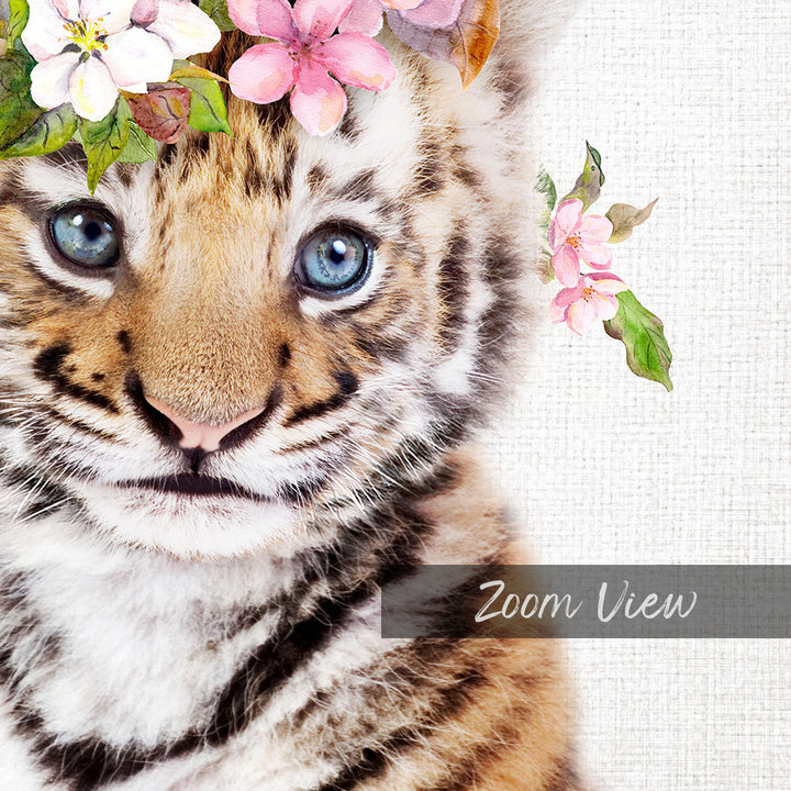 A close-up of a tiger cub's face, with its striking blue eyes and distinctive striped pattern, is the focal point of the image. The cub is adorned with a floral headpiece, adding a touch of whimsy to the scene. The background is a simple white canvas, which serves to highlight the details of the cub and its surroundings. The image is a zoom view, allowing the viewer to see the finer details of the tiger cub's features and the floral elements.