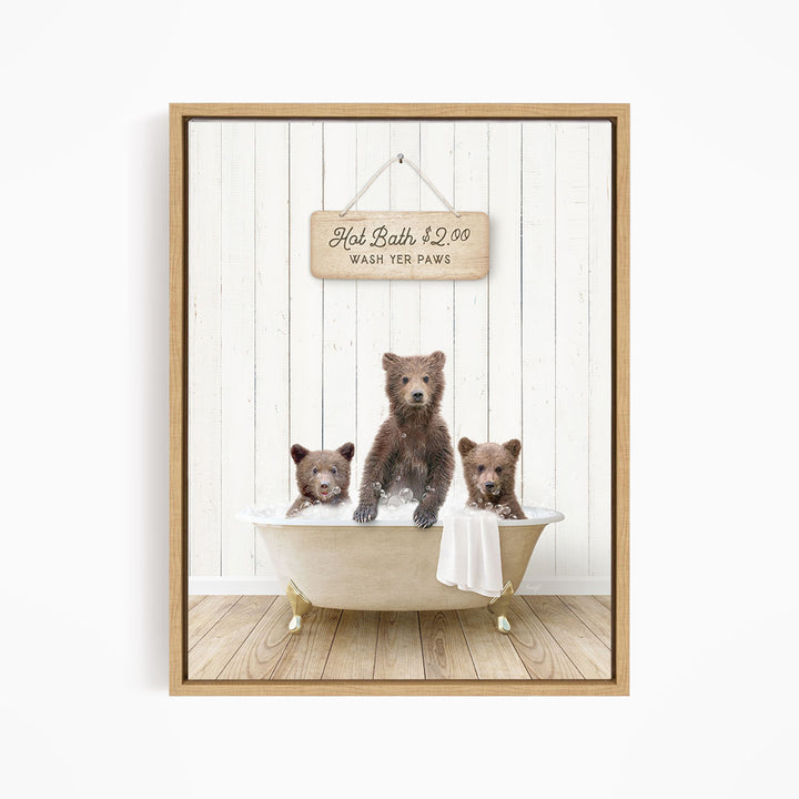 A wooden sign with the text "Hot Bath $2.00 WASH YER PAWS" hangs above a white bathtub filled with three adorable brown bears enjoying a bath.