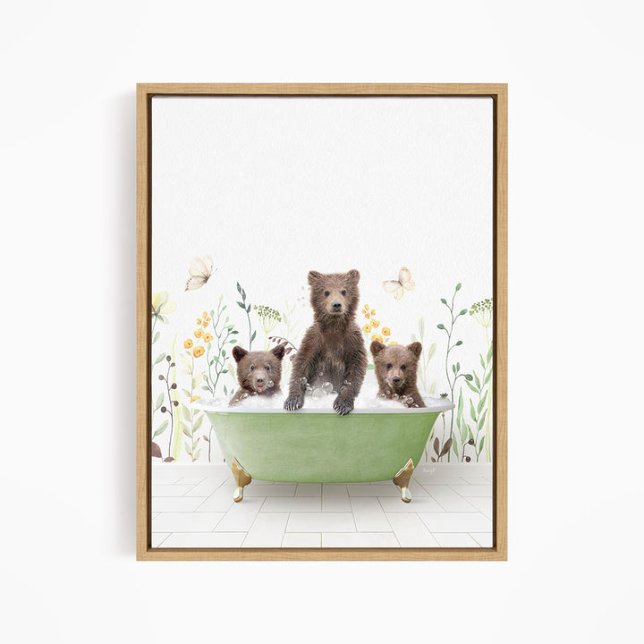 A framed print depicting three bears sitting in a green bathtub filled with water, surrounded by flowers and butterflies.