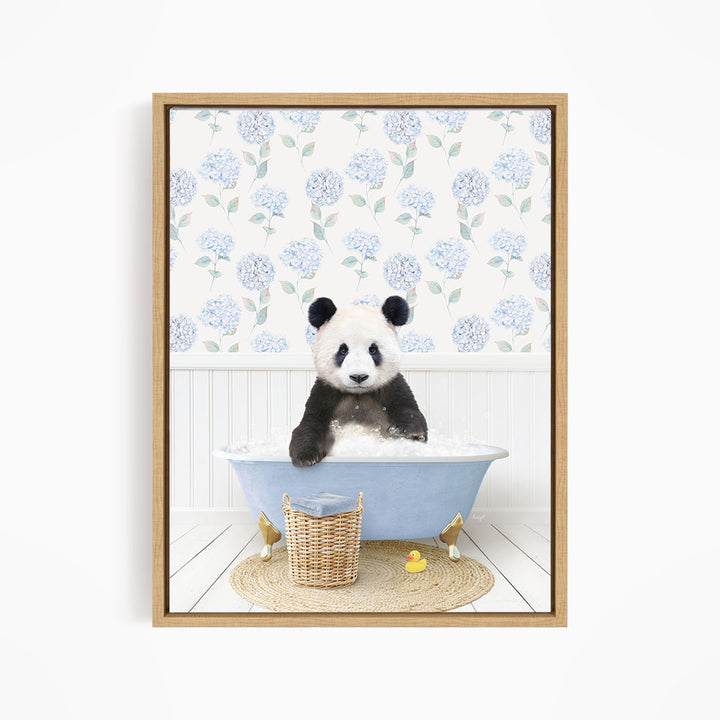 A panda bear sitting in a blue bathtub filled with bubbles, surrounded by a wicker basket and rubber duckies.