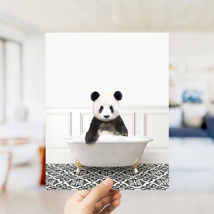 A panda bear sitting in a bathtub filled with bubbles, surrounded by a black and white patterned floor.