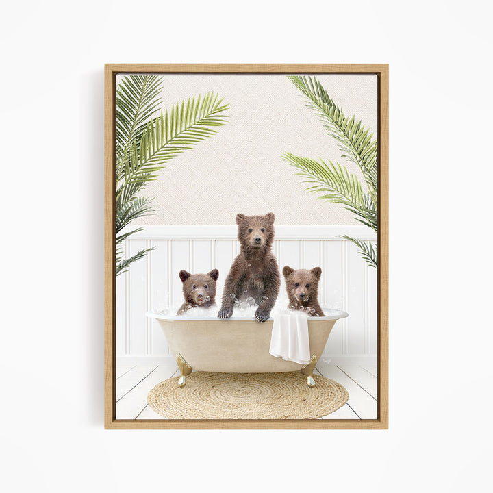 A framed image depicting three bears sitting in a bathtub, surrounded by palm leaves.
