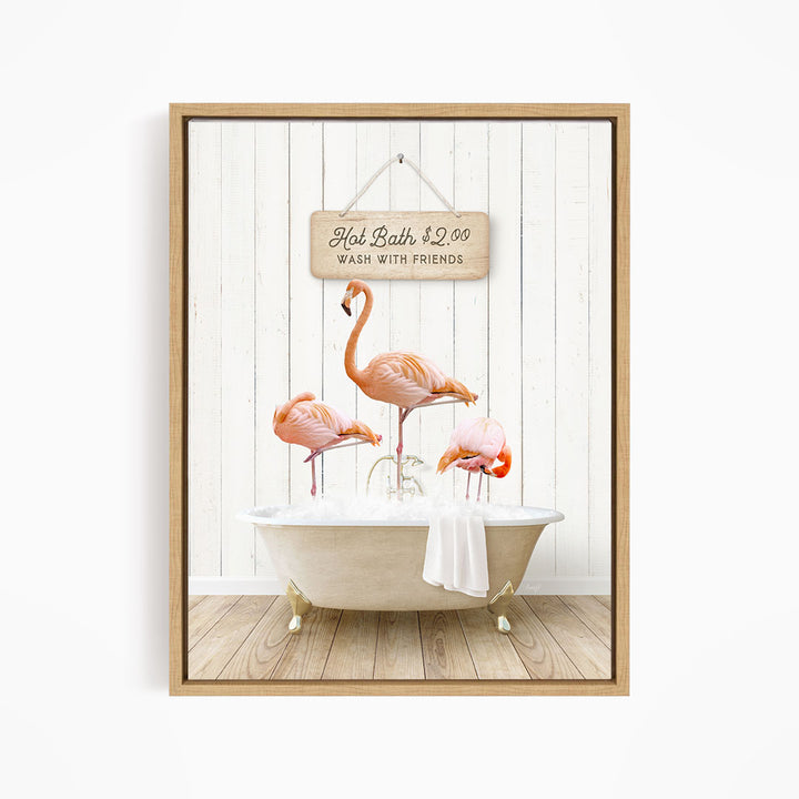 A framed image depicting three flamingos standing in a bathtub, with a sign above them that reads "Hot Bath $2.00 WASH WITH FRIENDS".