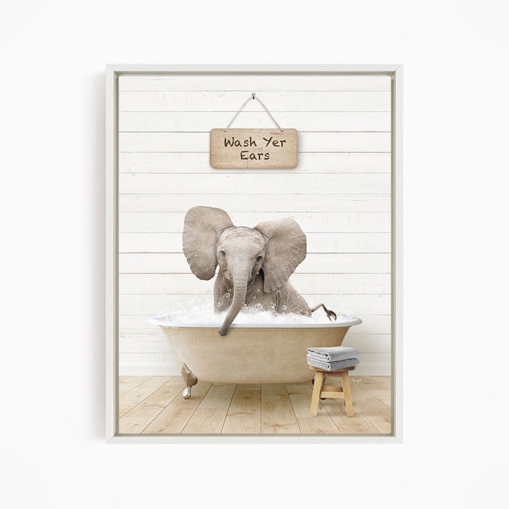 A gray elephant is sitting in a bathtub filled with water, with a sign above it that says "Wash Your Ears".