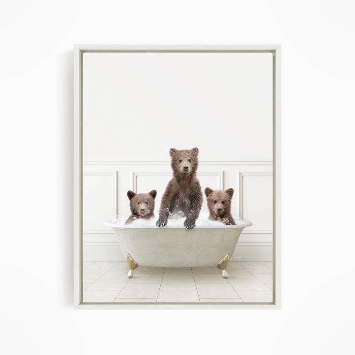 Three brown bears sitting in a white bathtub, with one bear sitting in the center and the other two bears sitting on either side.