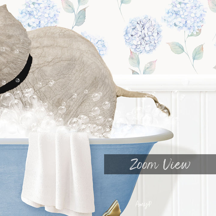A gray elephant is sitting in a blue bathtub filled with bubbles, with a towel hanging on the side and a floral wallpaper in the background.