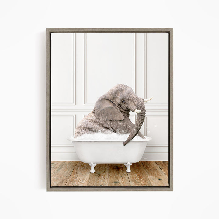 A gray elephant is sitting in a white bathtub filled with water, creating a whimsical and playful scene.