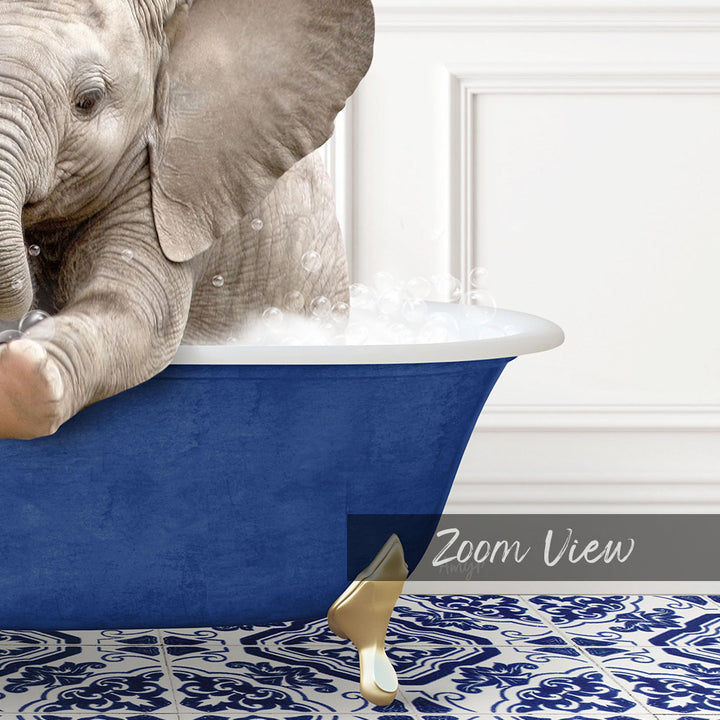 A baby elephant sitting in a blue bathtub filled with water, surrounded by a patterned tile floor.