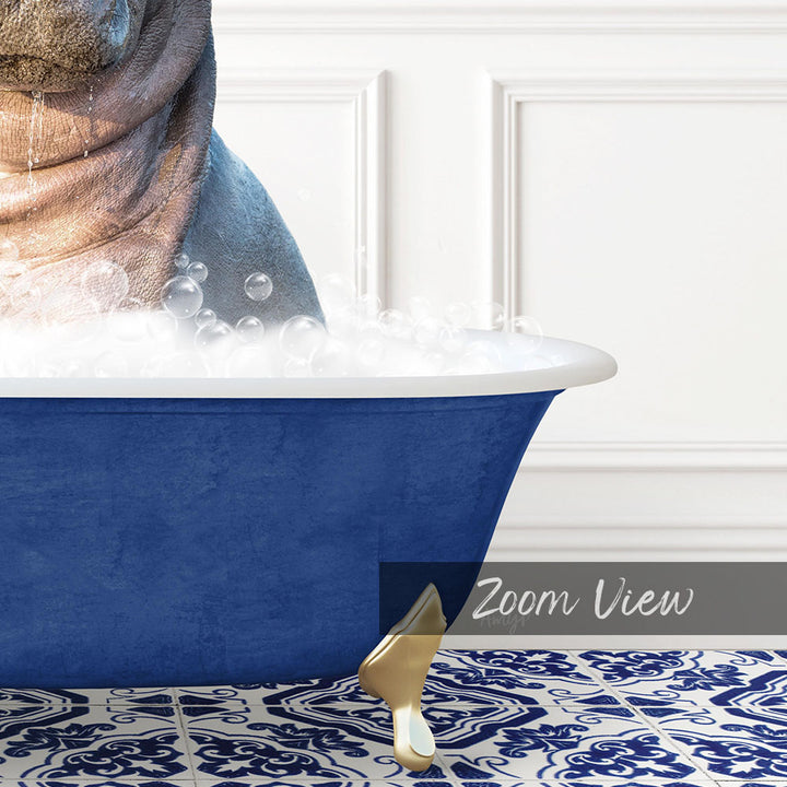 A close-up of a blue bathtub filled with bubbles, with a gold bathtub leg visible.