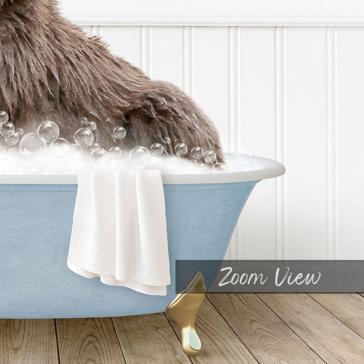 A fluffy brown dog is sitting in a blue bathtub filled with bubbles, with a white towel and gold bathtub stopper nearby.