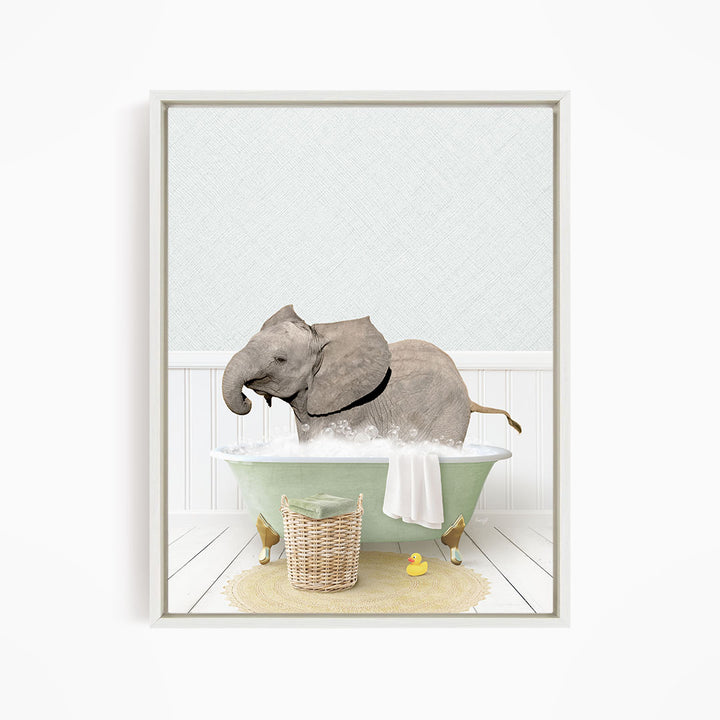 A gray elephant is sitting in a green bathtub filled with water, surrounded by a yellow rubber duck and a basket.