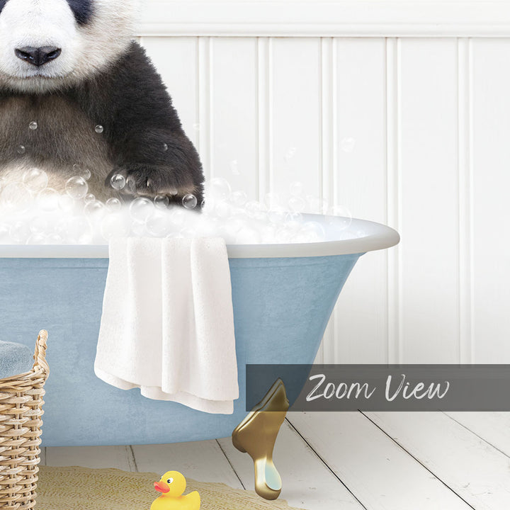 A panda bear sitting in a blue bathtub filled with bubbles, surrounded by a yellow rubber duck and a towel.