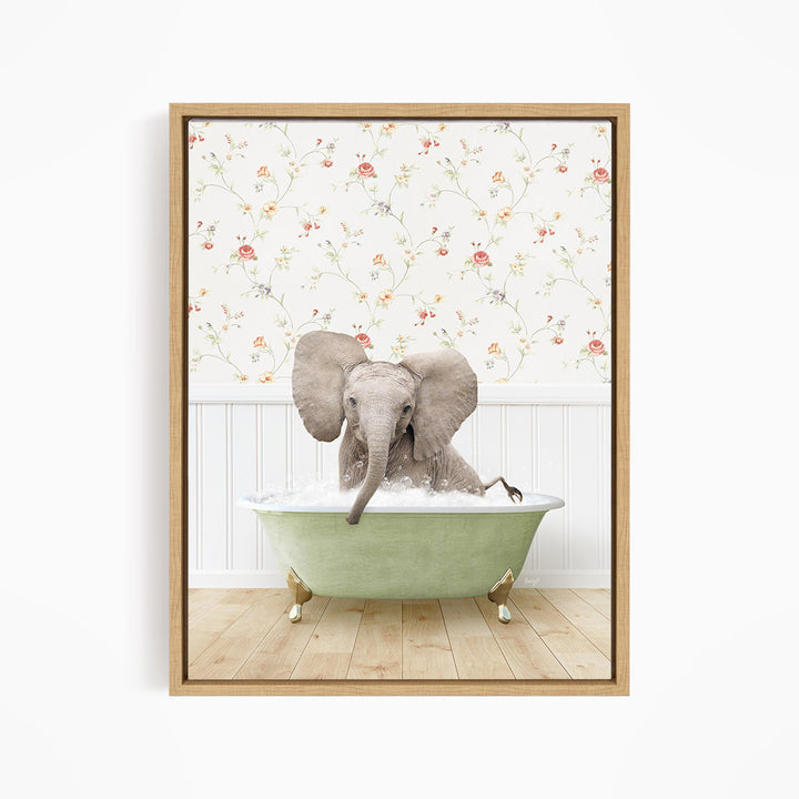 A baby elephant sitting in a green bathtub filled with water, surrounded by a floral wallpaper.