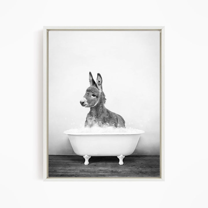 A donkey is sitting in a white bathtub filled with water, creating a whimsical and playful scene.