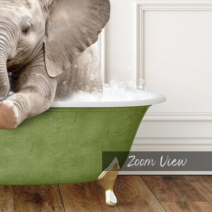 A baby elephant sitting in a green bathtub filled with bubbles, with a white door and wooden floor in the background.