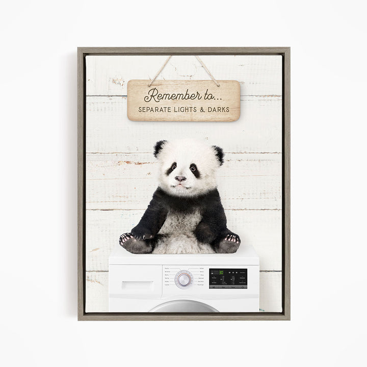 A panda bear sitting on top of a washing machine, with a wooden sign above that says "Remember to... Separate Lights & Darks".