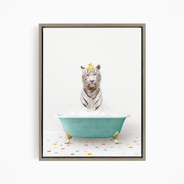 A white tiger is sitting in a green bathtub filled with bubbles, wearing a yellow duck hat.