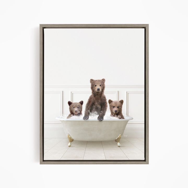 Three brown bears sitting in a white bathtub, with one bear sitting in the center and the other two bears sitting on either side.